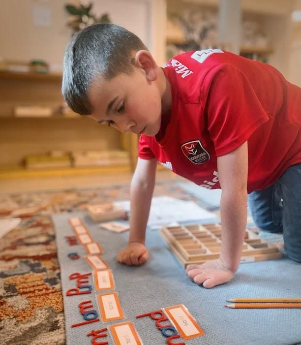 A young boy playing with a game board.